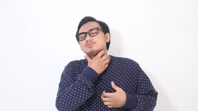 Footage of adult Asian man scratching his neck and showing uncomfortable expression