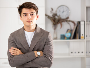 Portrait of businessman who is at his work place in office