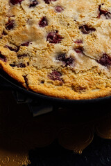 close up of cherry clafoutis in cast iron skillet