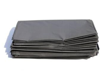 Black garbage bags on white backgrond.