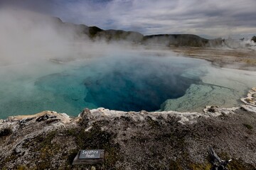 Blue pool stands in a grassy field