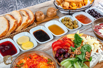 Traditional delicious modern Turkish cuisine. Plain Turkish breakfast with copper-pan egg dishes, pastries such as börek and bagels, jams, olives, cheeses, vegetables and Turkish tea.