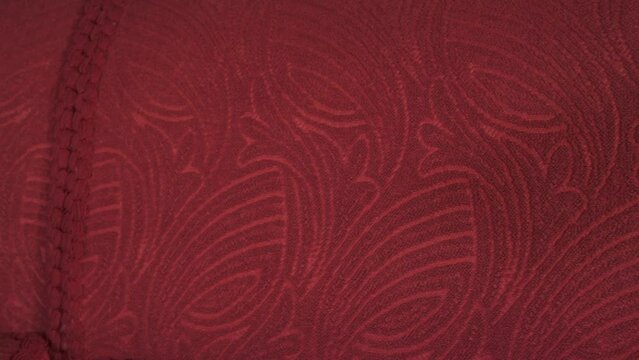 Shot of a red couch tecture with patterns.