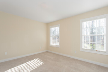 Bright Empty Room with Windows and Beige Walls, Carpet Flooring