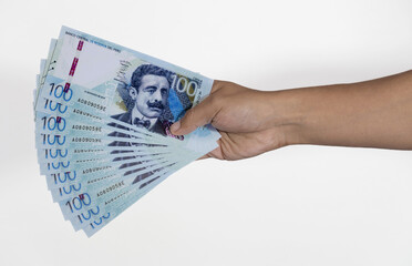 male hand holding fan of banknotes on white background peruvian sol - peruvian salary