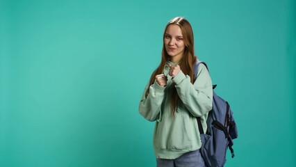 Woman doing fighting stance, pretending to do boxing, isolated over studio background. Young fighter throwing punches, doing athletic guard pose during combat practice, camera B - Powered by Adobe