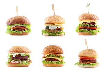 Different delicious vegetarian burgers isolated on white, set