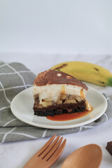 Homemade Banoffee cake made from bananas, whipped cream and a thick caramel sauce on table.