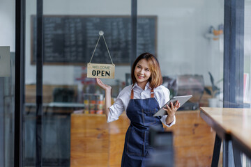 Startup successful small business owner sme beauty girl stand with tablet smartphone in coffee shop...