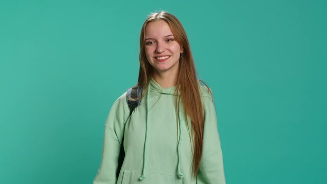 Young actress goofing around, switching emotions, trying different facial expressions, practicing for theatre class, studio background. Teenage woman making silly faces, camera A