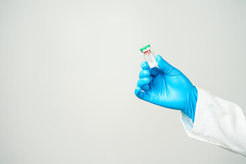 virus vaccine bottle for injection in hand of doctor or Technician scientist