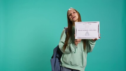 Portrait of smiling student holding high school diploma, celebrating passing classes with high marks, attending graduation ceremony. Happy young girl delighted about receiving certification, camera B