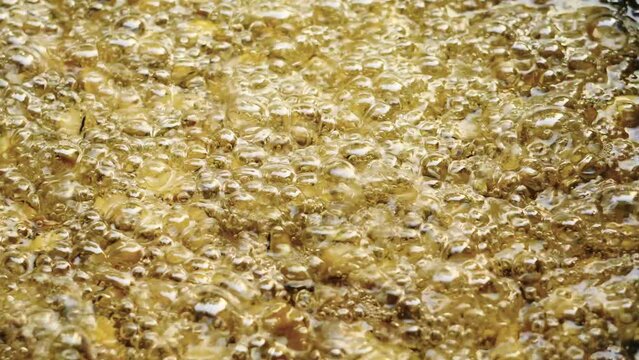 closeup of hot bubbling boiling oil background.