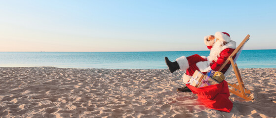 Santa Claus resting at sea resort. Christmas vacation