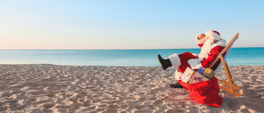 Santa Claus resting at sea resort. Christmas vacation