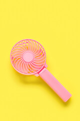Modern manual fan on yellow background