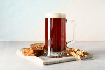 Mug of tasty kvass, bread and spikelets on white background