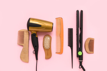 Different hairdressing tools on pink background