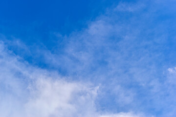 beautiful blue sky and white fluffy group of clouds with sunrise in the morning, natural background