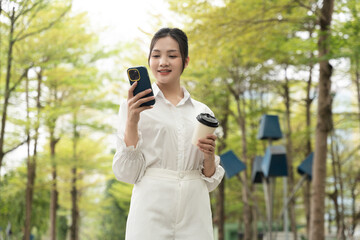 Portrait of young Asian businesswoman in the park