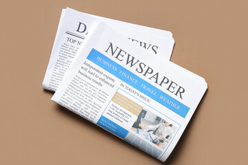 Different newspapers on brown background