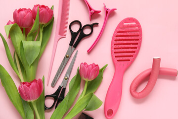 Hairdresser's tools with beautiful tulips on pink background