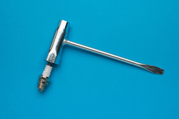 Spark Plug Wrench on Blue Background - Essential Tool for Automotive Maintenance and Repair