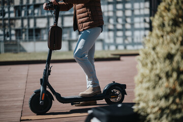 A man riding an electric scooter on a sunny day in the city, showcasing urban mobility and modern...