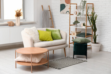 Interior of living room with comfortable sofa and olive pillows