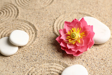 White spa stones with flower on light sand
