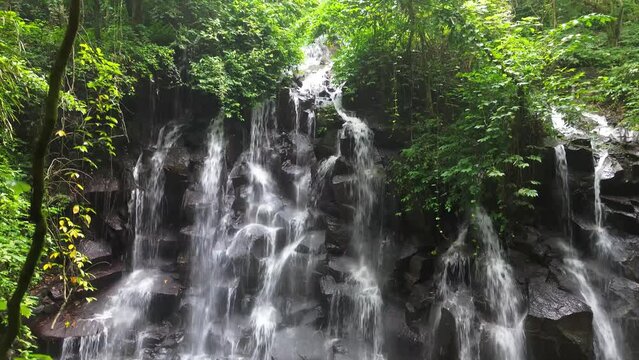 Kanto Lampo, a big cascade waterfall with a shallow pool and a bat cave nearby, Bali, Indonesia