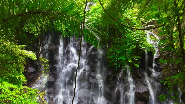 Kanto Lampo, a big cascade waterfall with a shallow pool and a bat cave nearby, Bali, Indonesia