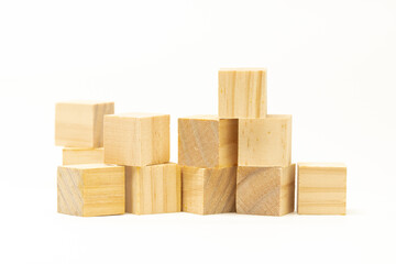 Random stack of wooden blocks or cubes isolated in white background.  