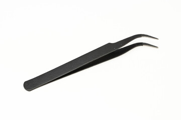 Black insulated tweezer isolated in white background. Used in electronic repair works.