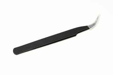 Black insulated tweezer with its tips covered isolated in white background. Used in electronic repair works.
