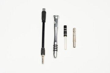 Parts of precision tool kit, contain  aluminum screwdriver handle, extension bar, flexible bar and power tool bit holder. Isolated in white background.