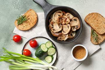Composition with fried mushrooms, bread and vegetables on grunge background