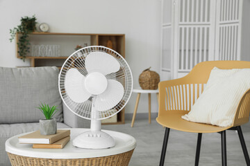 Modern electric fan on coffee table in living room