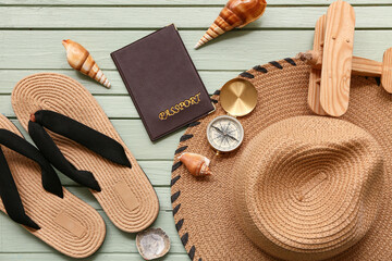 Composition with stylish beach accessories, passport and seashells on color wooden background