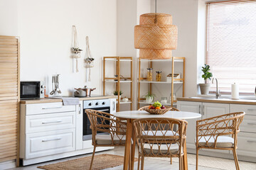 Dining table, chairs and lamp in stylish kitchen