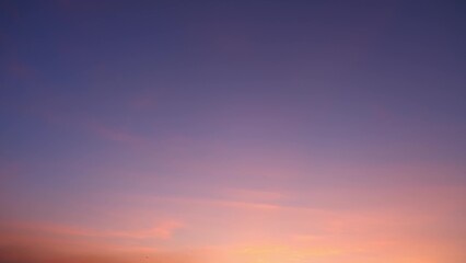 A stunning sunset with a gradient sky transitioning from deep purple at the top to warm orange and...