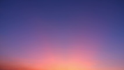 A tranquil sunset with a smooth gradient of colors. The sky transitions from deep blue at the top...