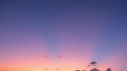 A breathtaking sunset with a gradient sky transitioning from deep blue at the top to soft pink and...
