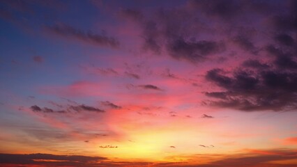 A breathtaking sunrise with vibrant colors transitioning from deep purples and blues at the top to...