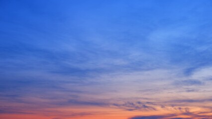 A stunning sunset with a sky that transitions from deep blue at the top to warm orange and pink...