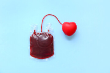 Blood pack with red heart on blue background. World Blood Donor Day