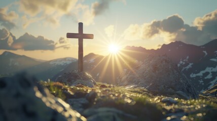 Obraz premium a cross on a mountain top with sun flare backlighting it.