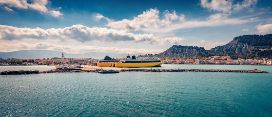 Panoramic summer cityscape of Zakynthos port with ferryboats. Colorful morning seascape of Ionian...