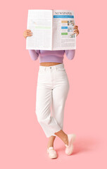 Young African-American woman with newspaper on pink background
