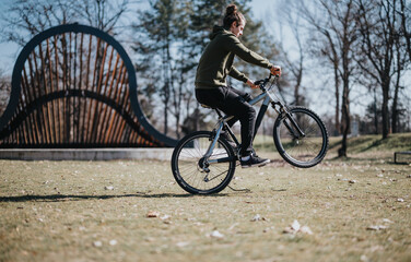 A casual, carefree man cycles through a lush park on a sunny day, embodying a moment of relaxation...
